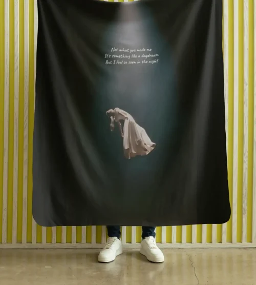- Ariana Grande merch banner with album artwork and lyrics on a dark background.