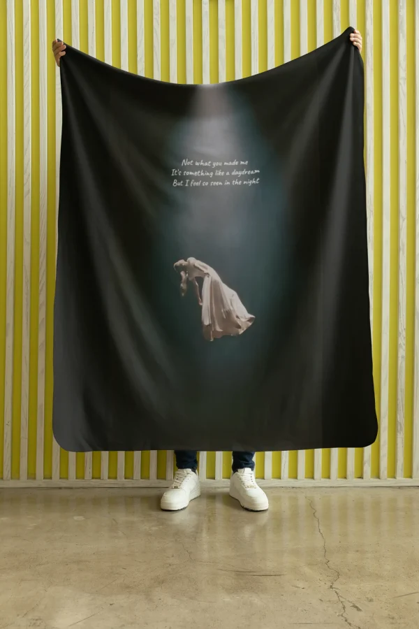 - Ariana Grande merch banner with album artwork and lyrics on a dark background.