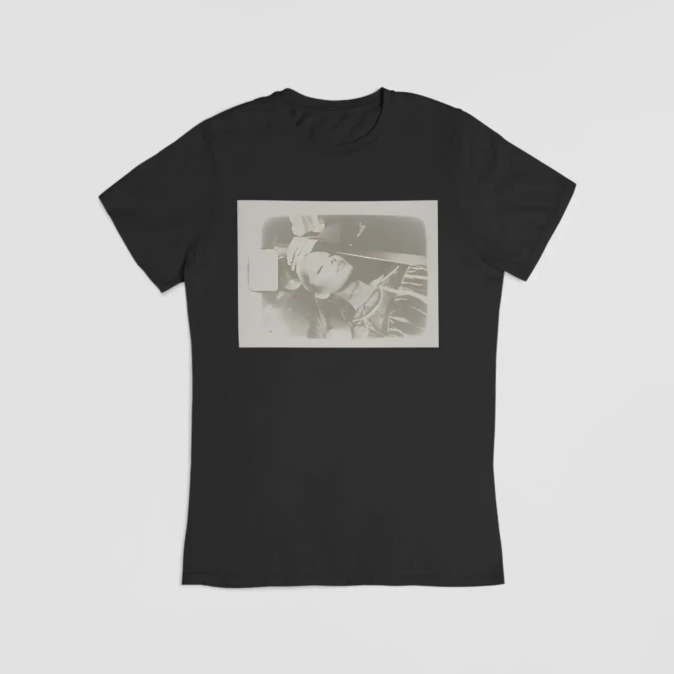 Black t-shirt with a monochrome photo of a woman sleeping in a car, fashion casual style.