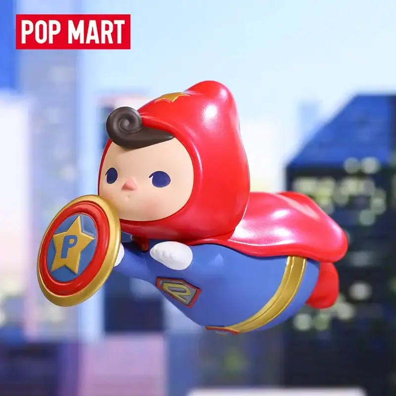 Superhero-themed collectible toy with a red cape, shield, and blue costume, inspired by comic book heroes, perfect for fans of superhero merchandise.