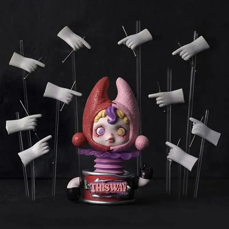 Ariana Grande merch, colorful collectible toy with a whimsical design featuring exaggerated facial features, surrounded by white gloves pointing in various directions.