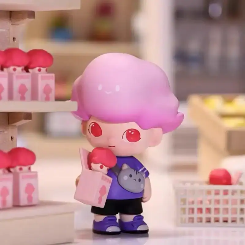 Cute anime-style plush toy with pink and purple hair, large red eyes, wearing a purple shirt with a gray bear design, holding a pink shopping bag.