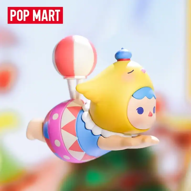 Pop mart cartoon character figure in colorful outfit with yellow hat.