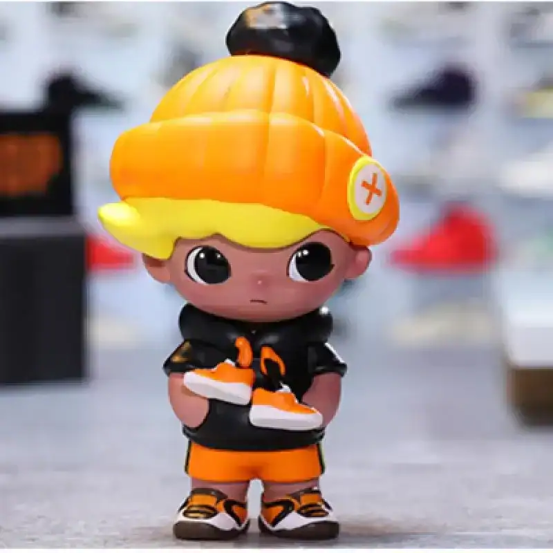 Adventurous cartoon character figure wearing a bright orange beanie and black hoodie with orange accents, holding a pair of sneakers.